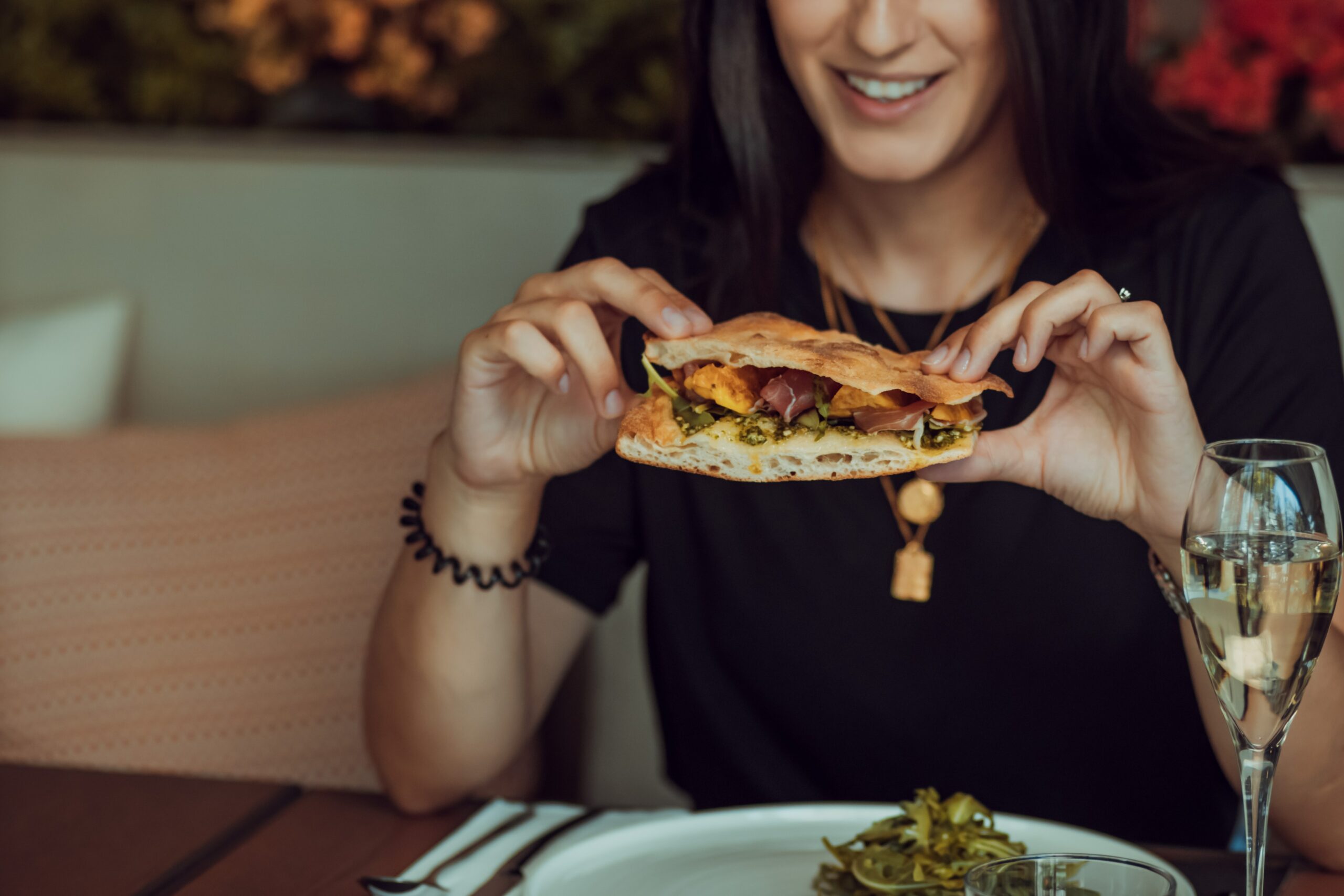 Women eating a sandwich smiling